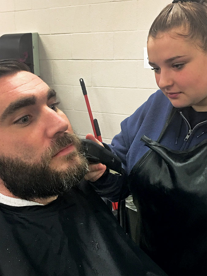 student trims beard