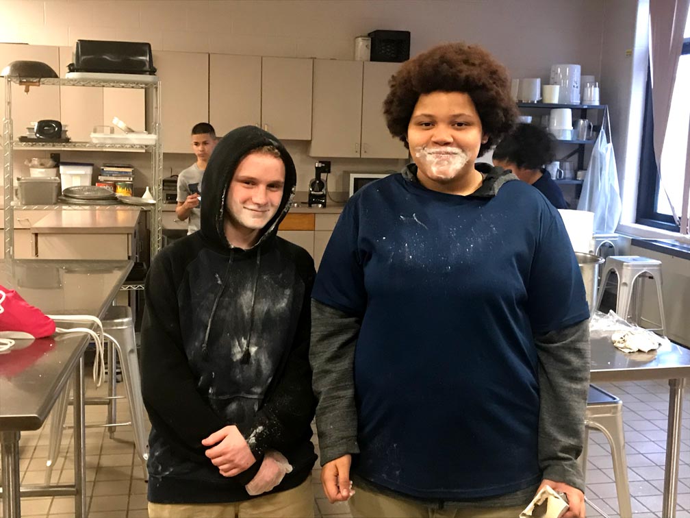 culinary students covered in flour