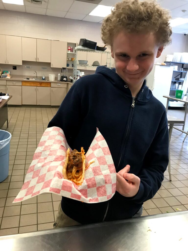 student shows off lunch creation